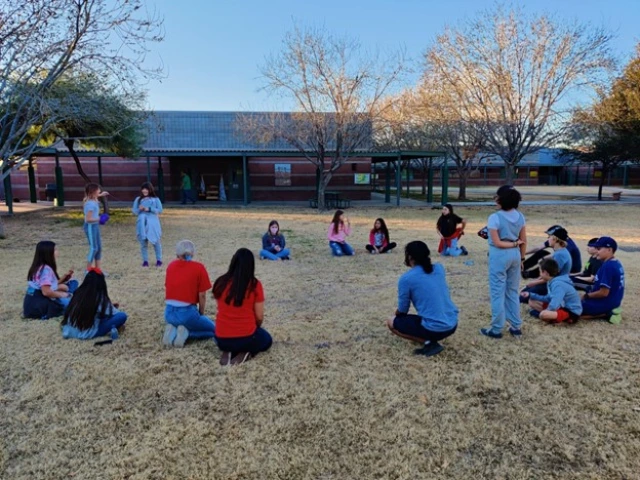 People playing outside in a circle 