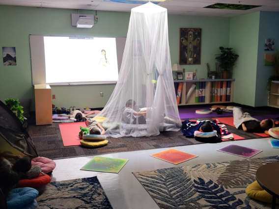 Little kids relaxing in the Zen Den with pillows and blankets. 