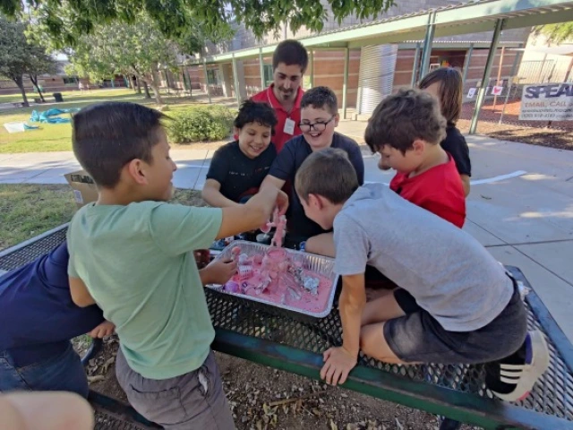Young Kids Playing with crafts at a picnic table 