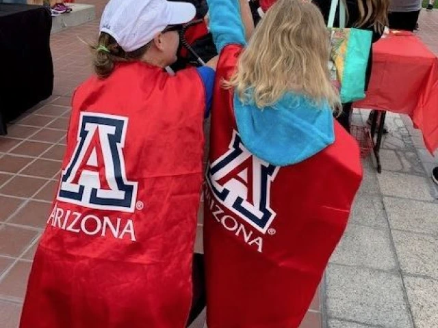 Wildcat Marathoners holding hands in the air