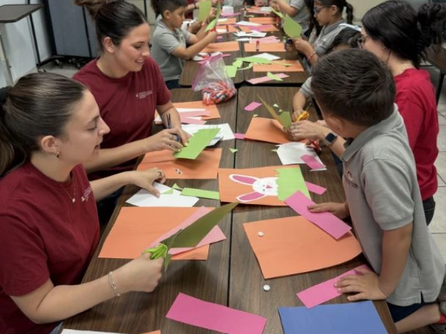 Kids and interns working on arts and crafts