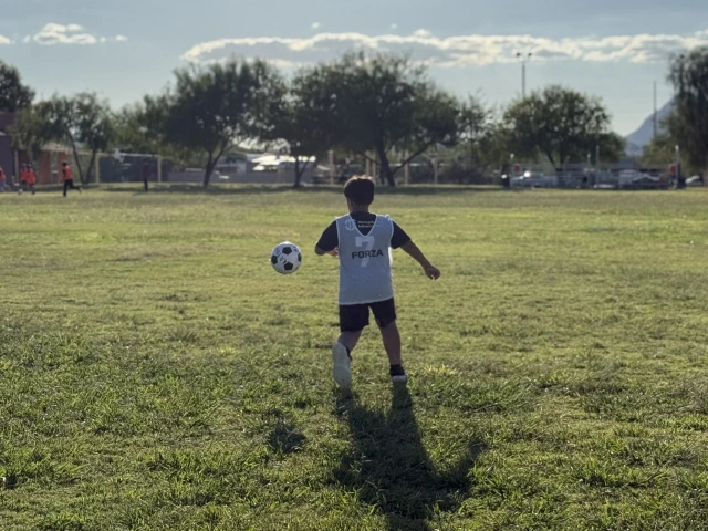 Kid kicking soccer ball 
