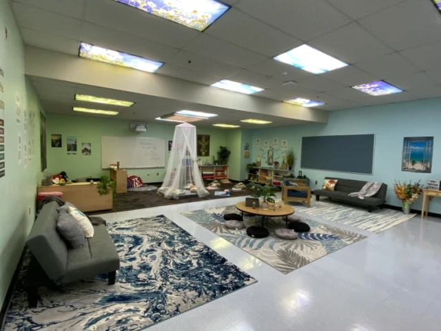 Classroom with couches, bean bags, rugs, for calming space. 