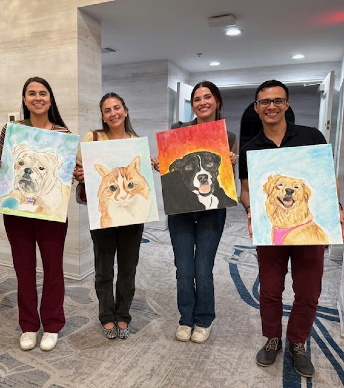 4 people holding up paintings of their pets.