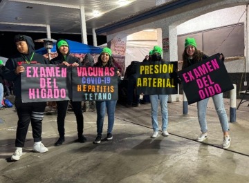 People holding signs for health services