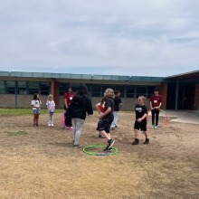 Kids playing outside with hula hoops 