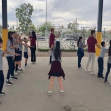 Students line dancing outside