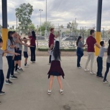 Students line dancing outside 