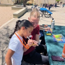 Little girl receiving her marks on her lanyard for walking the track.