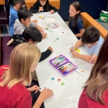 Kids doing arts and crafts at a table